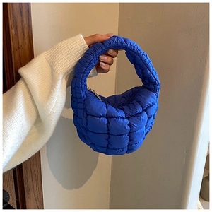 Detail view of royal blue quilted cloud bag with padded texture and silver zipper
