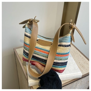 Macro detail of rainbow woven texture and brown adjustable strap with golden buckle