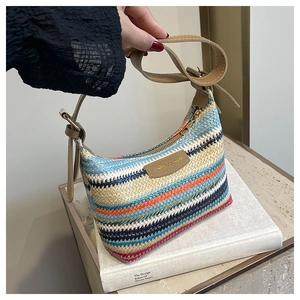Close-up of rainbow woven texture with multicolored stripes and brown leather strap