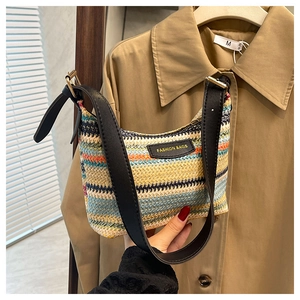 Close-up of rainbow woven straw texture with Fashion Bags label and black leather strap