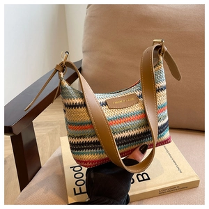 Detail of colorful rainbow woven texture and brown leather strap on a summer shoulder bag