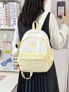 Creamy yellow tie-dye nylon backpack with panda plush charm and spacious compartments