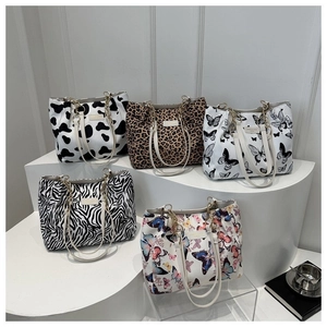 Fashionable large canvas tote bags with leopard and butterfly prints and chain handles