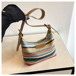 Detail of bohemian rainbow woven shoulder bag with leather strap and fashion logo