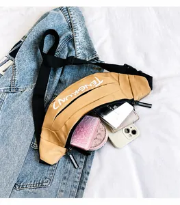 Detail view of khaki crossbody bag showing large internal capacity with personal items