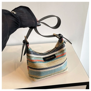 Detail of colorful woven shoulder bag showing rainbow stripes and fashion label