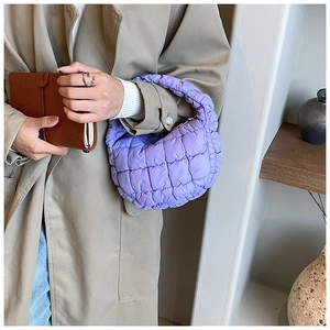 Detail of purple quilted cloud handbag showing pleated texture and nylon fabric finish