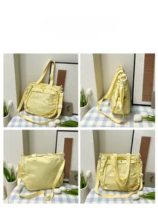 Detail view of yellow tote bag with clear PVC window and delicate ruffled lace trim