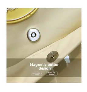 Detail of silver magnetic buckle closure on high-density beige canvas tote bag