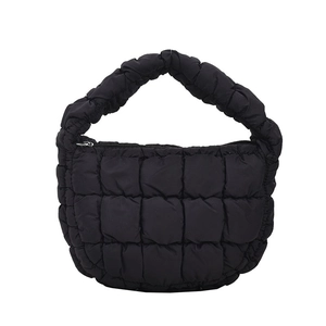 Minimalist black quilted cloud bag with puffy nylon finish and top handle design