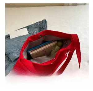 Top view of red corduroy tote bag showing large capacity for books and tablet