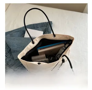 Top view of large capacity beige tote bag showing spacious storage for daily items