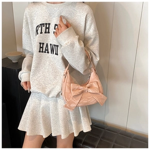Pink bow handbag with marble texture shown with a minimalist outfit style
