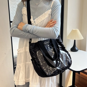 Black canvas tote bag with clear PVC window and ruffled trim detail for women