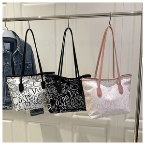 Detailed display of graffiti print canvas tote bags in white, black and pink color options