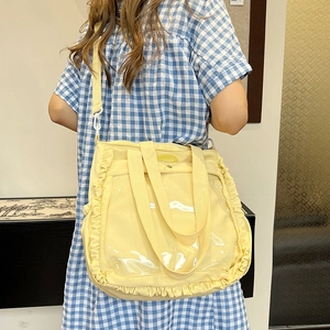 Light yellow ruffled tote bag with transparent front pocket and adjustable shoulder strap