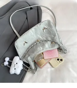 Macro view of silver tote bag interior showing large capacity for phone and perfume