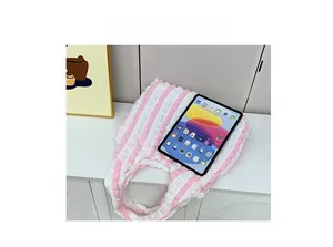 Pink striped quilted bubble tote bag showing large capacity by holding a tablet device