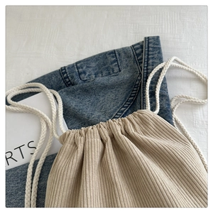 Detail shot of soft corduroy drawstring bag with durable white cotton rope closure