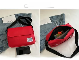 Detailed view of red canvas crossbody bag showing internal storage for phone and keys