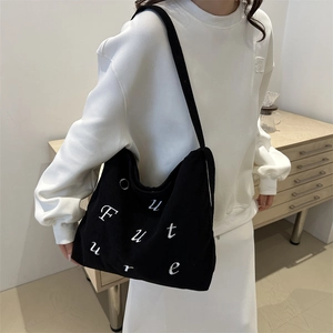 Black corduroy tote bag with 'Future' embroidery shown from a 45-degree angle