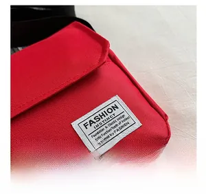 Detailed macro view of the premium red oxford fabric texture and white fashion label