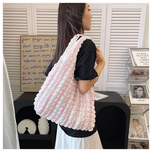 Detail of pink and white striped tote bag with ruffled edges and bubble pleat texture