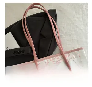 Close-up of pink long handles and artistic graffiti on white canvas tote bag