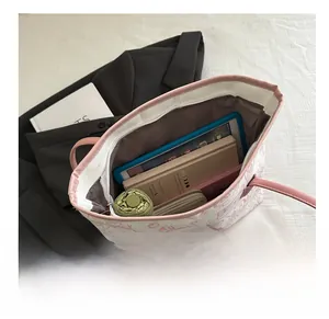 Large capacity tote bag showing interior space for tablet, umbrella and notebook