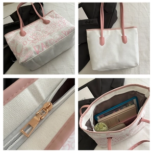 Detail showing high-capacity canvas tote bag with pink straps and graffiti art print