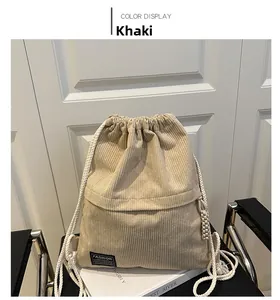 Detailed texture of khaki corduroy drawstring backpack with black fashion label