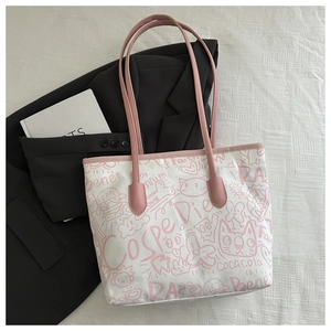 Detail of graffiti canvas tote with pink leather handles and cute cat burger prints