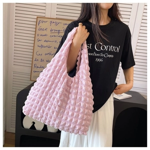 Close-up of pink 3D popcorn texture on a large stylish pleated hobo shoulder bag