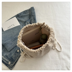 Spacious interior of beige corduroy drawstring backpack showing daily essentials