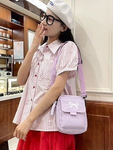 Lavender purple canvas messenger bag with white bow embroidery and adjustable strap