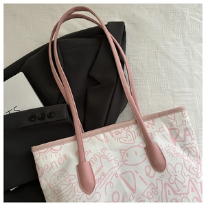 Close-up of doodle canvas tote with pink cat graphics and "Faith" lettering detail
