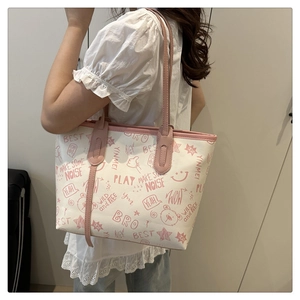 Close-up of contrast tote bag with pink artistic graffiti prints and bear patterns