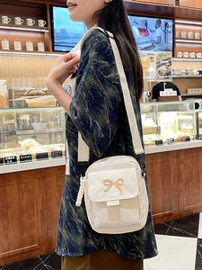 Japanese style white canvas crossbody bag with cute bow embroidery for daily commute