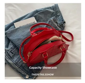 Macro view of large red handbag showing internal capacity for phone and wallet