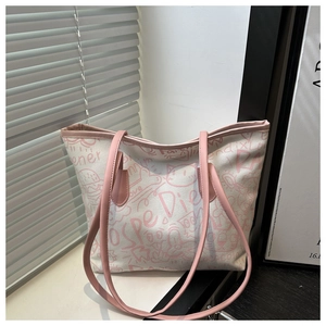 Close-up of pink doodle canvas tote bag with leather straps and reinforced stitching