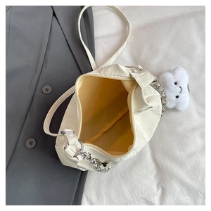 Top view of cream white tote bag showing spacious yellow lining and silver chain detail