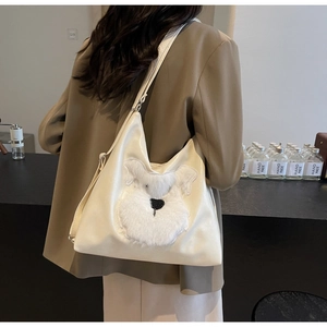Détail du sac cabas en similicuir crème avec broderie chiot en peluche sur bandoulière chic