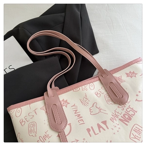 Detailed shot of pink and white PU leather tote with colorful graffiti prints and icons