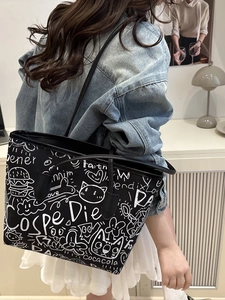Graffiti canvas tote bag with hand-drawn art and large capacity for daily commuting