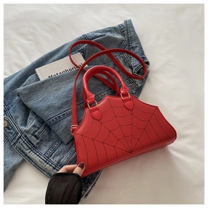 Detail of red spider web embroidery on a gothic style coffin shaped faux leather handbag