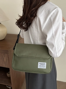 Minimalist dark green oxford shoulder bag for men and women with adjustable black strap