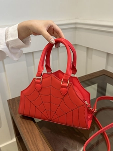 Vibrant red spider web embroidered handbag with top handles and crossbody strap