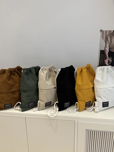 Minimalist corduroy drawstring backpacks in six colors including brown and dark green