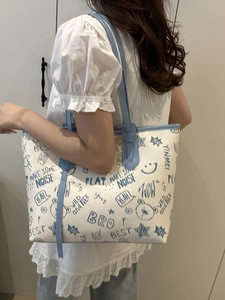 White tote bag with blue graffiti street style prints and blue leather handles