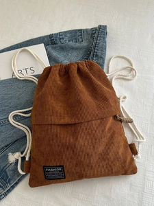 Brown corduroy drawstring backpack with retro fashion instinct patch and cotton ropes